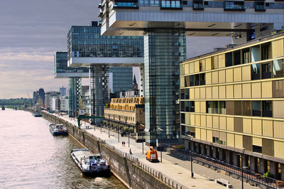 Canal amidst buildings in city against sky