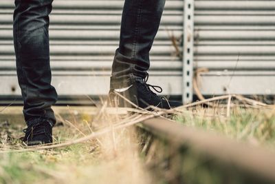 Low section of man standing on grass