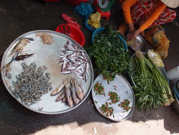 Low section of vendor selling vegetables and fish in market