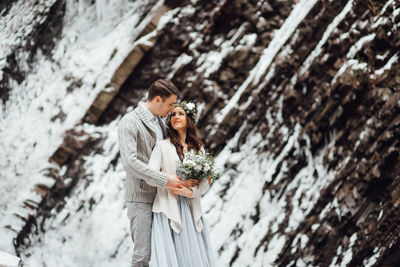 Young couple standing on snow