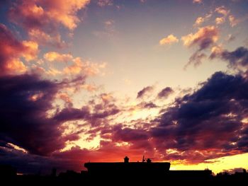 Silhouette of building against dramatic sky