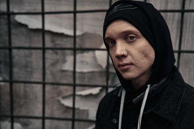 Portrait of young man against wall