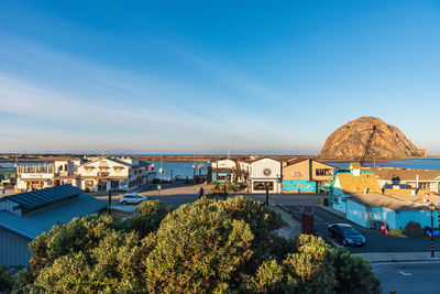 High angle view of buildings against blue sky