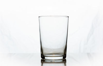 Close-up of drink in glass against white background