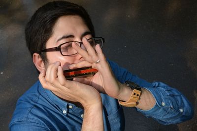 Young man playing harmonica