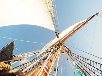 Low angle view of sailboat against clear blue sky