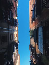 Low angle view of buildings against blue sky