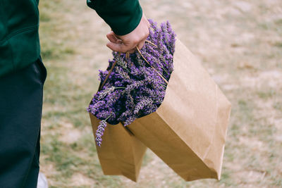 Man carrying bag of flowers
