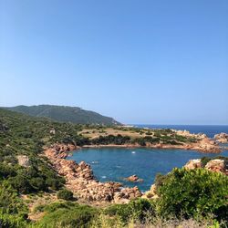 Scenic view of bay against clear blue sky