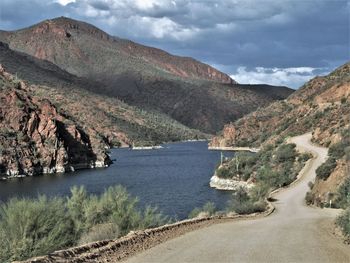 Scenic view of river amidst mountains against sky