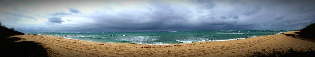 Scenic view of sea against cloudy sky