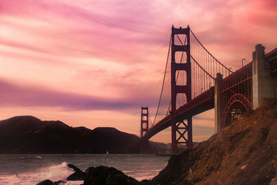 Scenic view of bridge over sea against cloudy sky