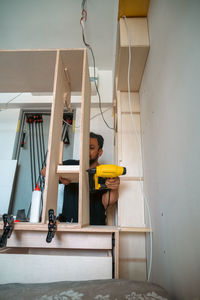 Low angle view of boy sitting on staircase