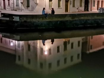 Reflection of buildings on puddle in city