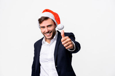 Portrait of smiling man standing against white background