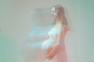 Digital composite image of woman standing against glass wall