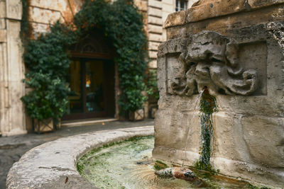 Statue against old building