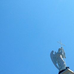 Low angle view of trees against clear blue sky