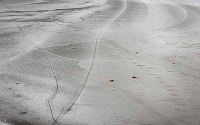 High angle view of footprints on wet street