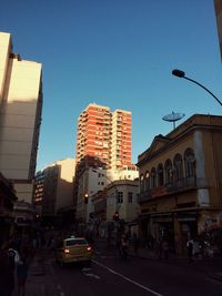Vehicles on road along buildings