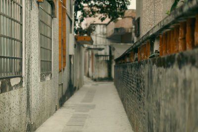 Footpath amidst buildings in city