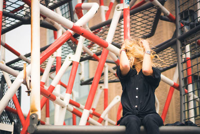 Full length rear view of woman standing in playground