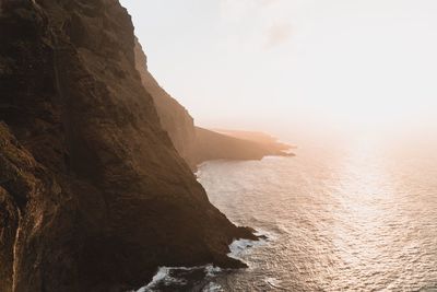 Scenic view of sea and mountains against clear sky