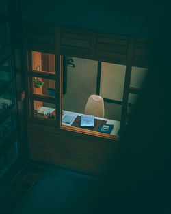 High angle view of empty chair by table