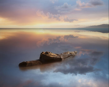 Scenic view of sea against sky at sunset