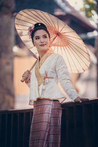 Portrait of young woman standing outdoors