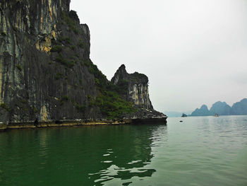 Scenic view of sea and mountain against sky