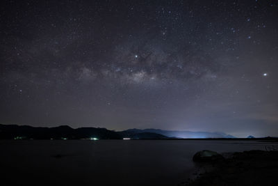 Scenic view of lake against star field at night