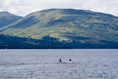 Scenic view of lake and mountains against sky