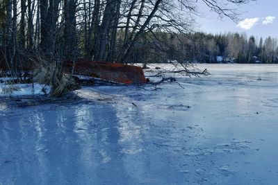 Scenic view of snow covered land against sky