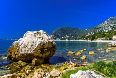 Scenic view of sea against clear blue sky