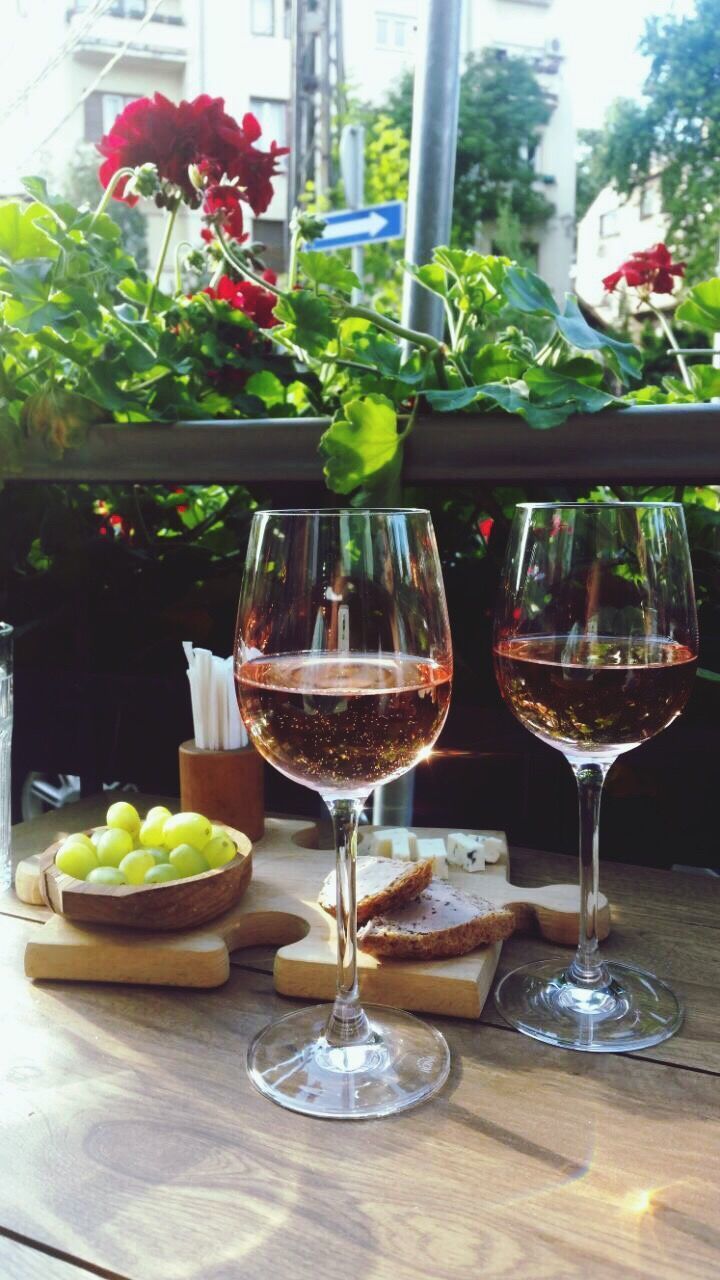 CLOSE-UP OF WINE GLASSES AND BOTTLES ON TABLE