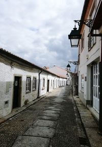 Empty alley amidst buildings in town
