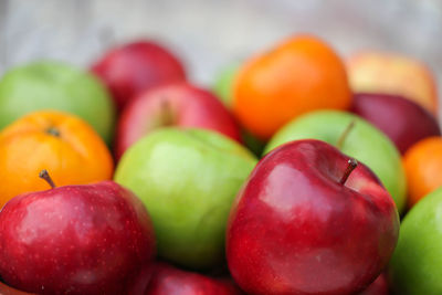 Red apple in a pile of fruit.