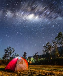 Tent on field against sky at night