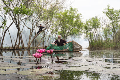 Senior man fishing in pond
