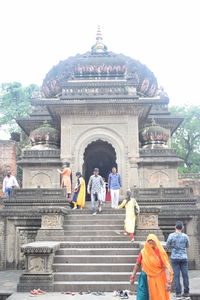 People at temple against building