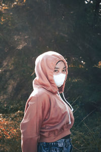 Portrait of woman standing in forest