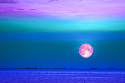 Scenic view of sea against moon at night