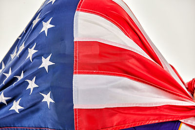 Close-up of red flag against blue sky