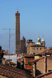 View of buildings in city against clear sky