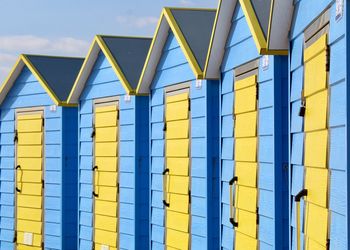 Low angle view of yellow building against sky