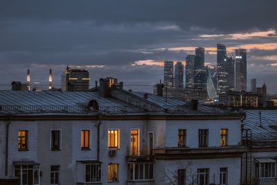 Buildings against sky at sunset