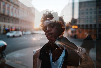 Portrait of man standing on city street