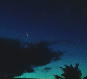 Low angle view of moon against blue sky