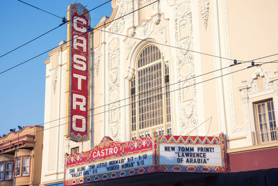 Low angle view of text on building against sky